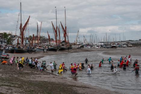 Competitors in costume participate in the Maldon Mud Race.