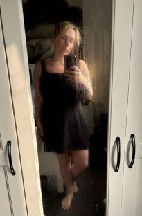 Woman taking a selfie in a mirror.