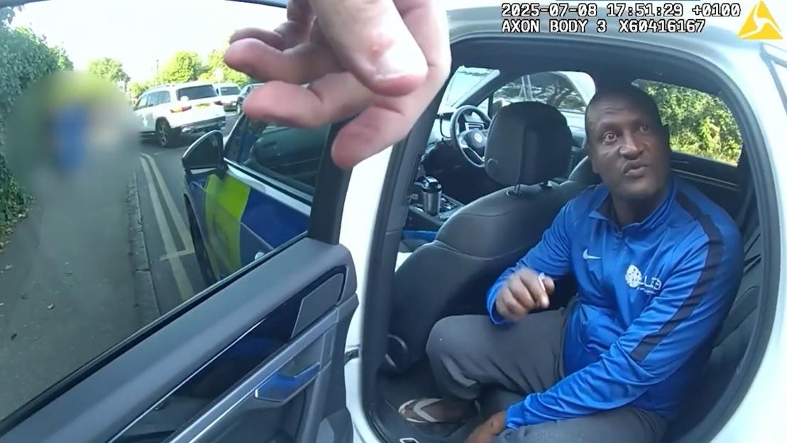 Body-worn camera footage showing Hadush Gerberslasie Kebatu in the front passenger seat of a car during his arrest.