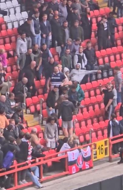 Shocking moment Millwall fan is punched and kicked before being dragged away by security in Charlton home end