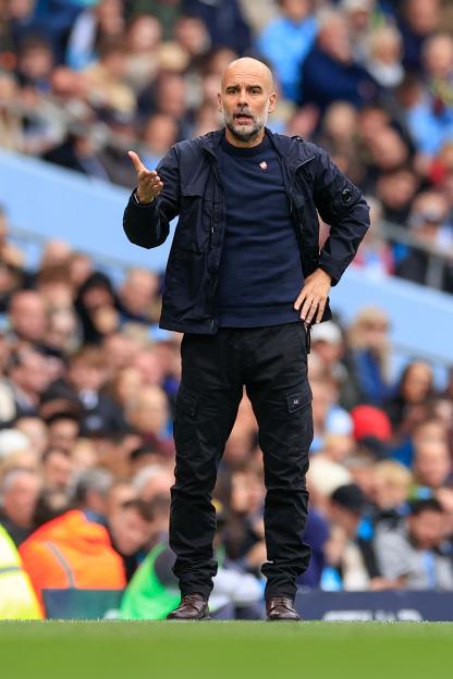 Pep Guardiola managing a Manchester City match against Burnley.