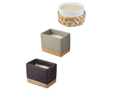 Three candles in different colored containers.