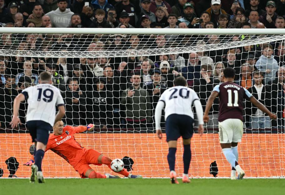 Bologna's Polish goalkeeper Lukasz Skorupski saves a penalty shot from Aston Villa's English striker Ollie Watkins.