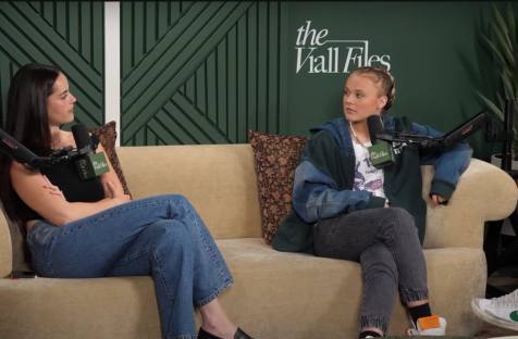 Two women sitting on a couch during a podcast interview.