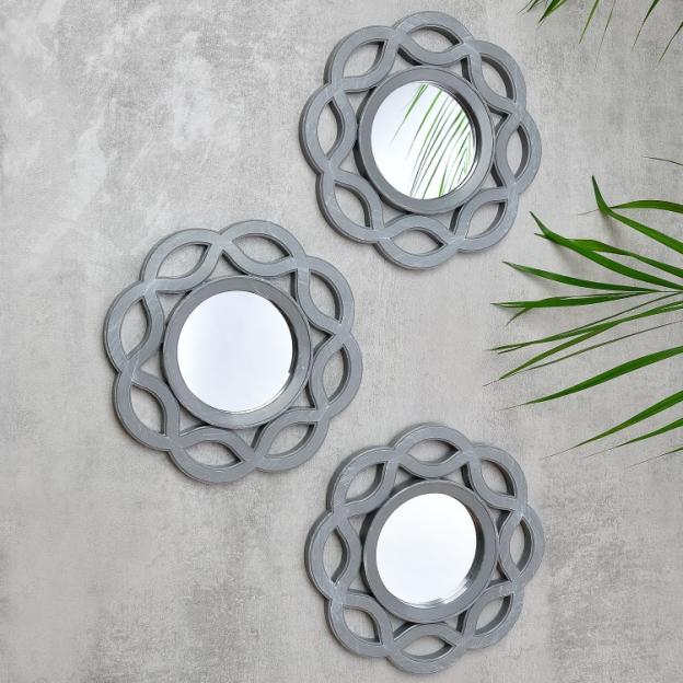 Three gray decorative mirrors with a floral design.