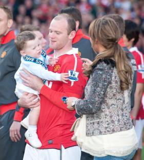 Wayne Rooney holding his son Kai.
