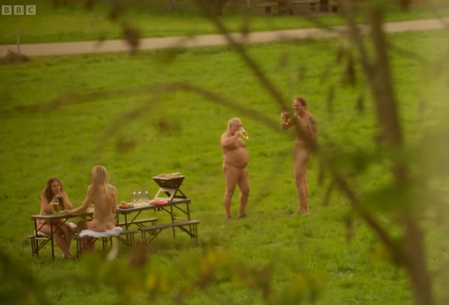 Naked people at a picnic.