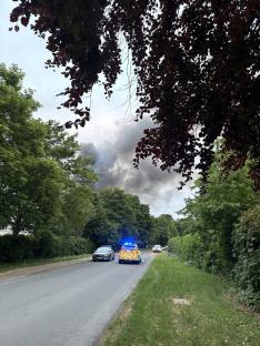 Police car near a large fire.