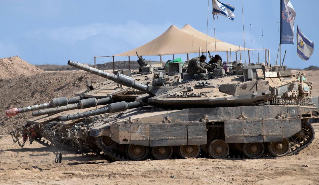 Israeli soldiers working on a tank near the Gaza Strip border.