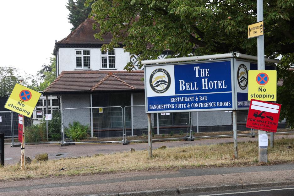 Photo of The Bell Hotel in Epping, UK, with signage indicating planned protests and no stopping zones.