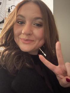Woman giving peace sign.