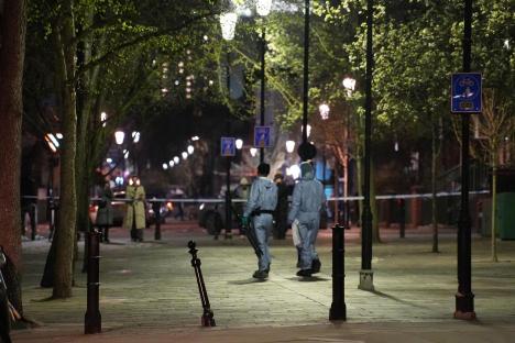 Forensic officers at a crime scene at night.