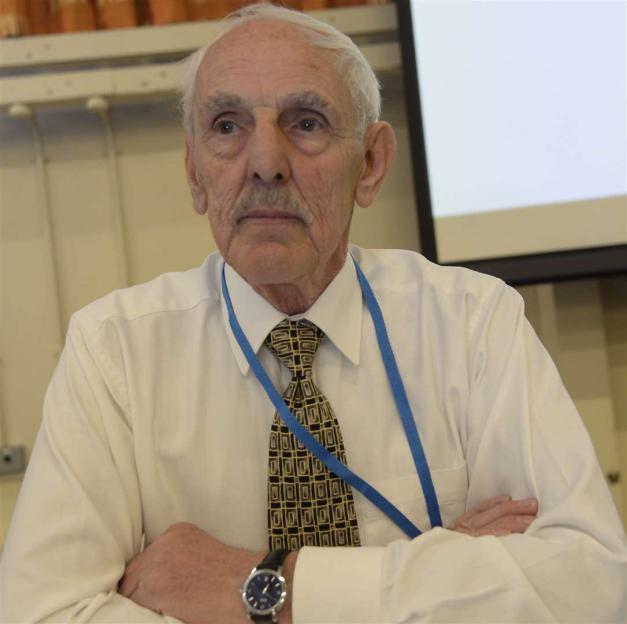 Health campaigner Ken Rogers sitting with his arms crossed and wearing a white shirt and patterned tie.