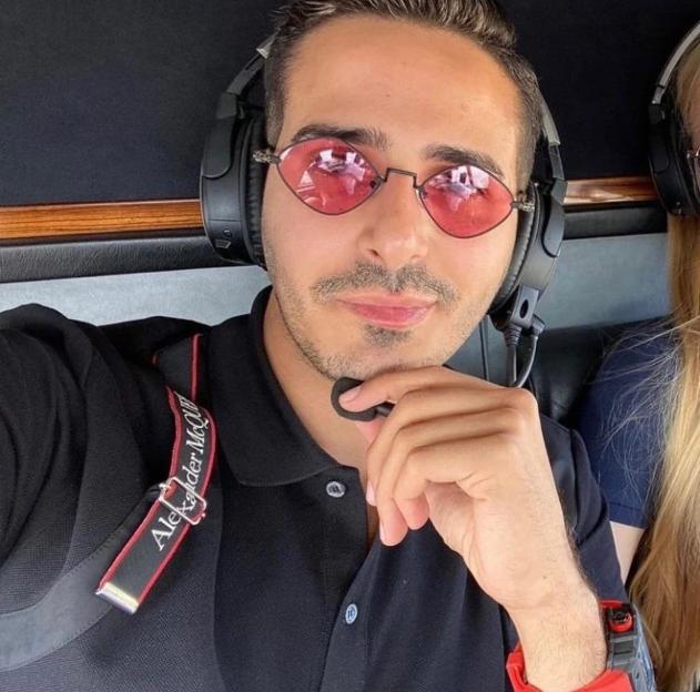 Man wearing pink sunglasses in a helicopter.