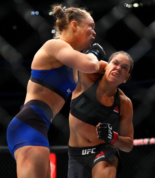 Amanda Nunes landing a punch on Ronda Rousey during a UFC match.