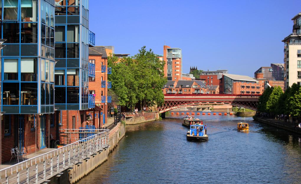 River Aire in Leeds, England, with boats and buildings.