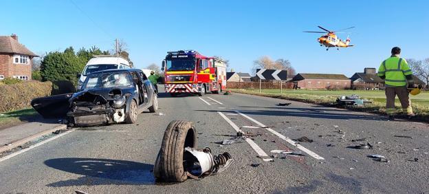Aftermath of a three-vehicle collision, with emergency responders on scene.