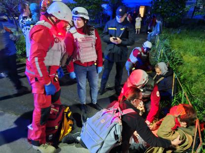 Ukrainian Red Cross paramedics providing first aid to a wounded man after a Russian drone strike in Kyiv.