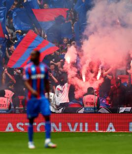 Crystal Palace fans lighting flares in the stands at Wembley Stadium.
