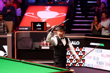 Zhao Xintong reacts during a snooker match.