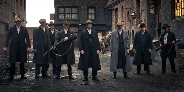 Peaky Blinders cast armed in alleyway.