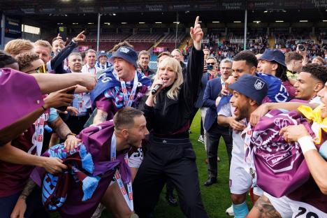 Natasha Bedingfield singing on the pitch after Burnley's promotion.