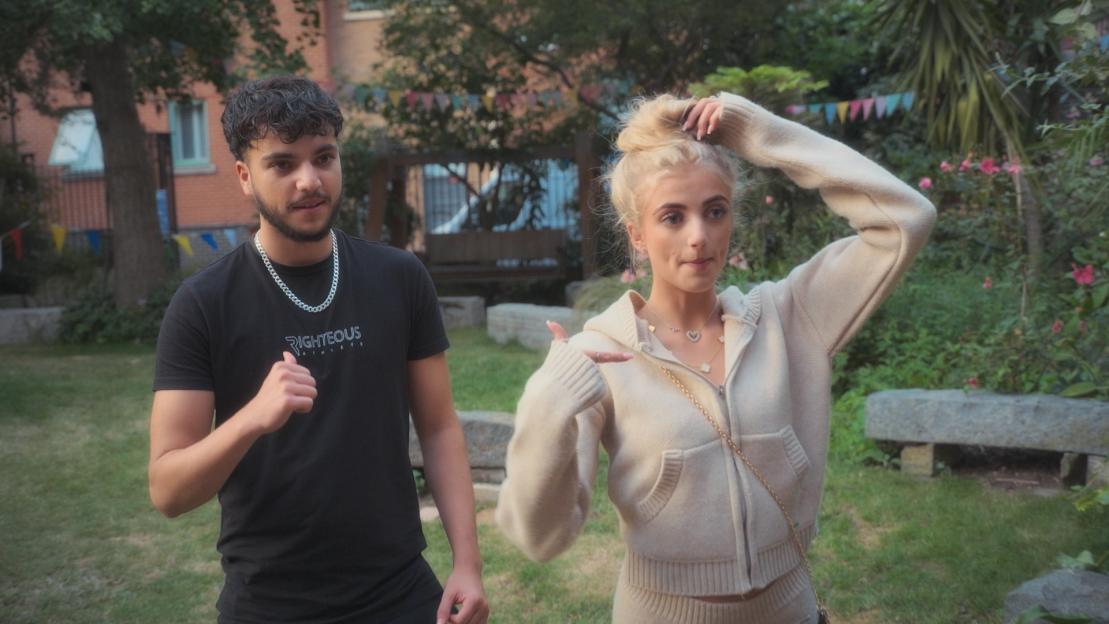 Photo of a young man and woman outdoors.
