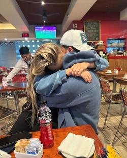 Couple hugging in a restaurant.