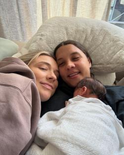 Sam Kerr, Kristie Mewis, and their baby, Jagger Mewis-Kerr, cuddling.