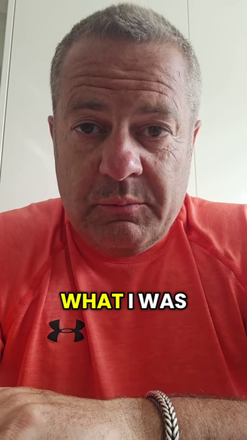 Man in red shirt with text "WHAT I WAS" on it.