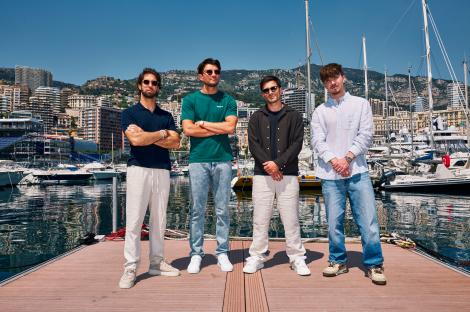 Four men standing on a dock in Monaco.