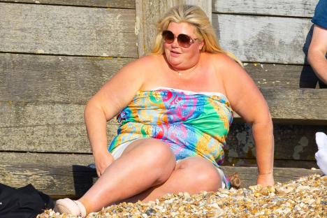 Gemma Collins soaks up the sun on the beach in strapless dress after revealing weight loss jabs had transformed her life