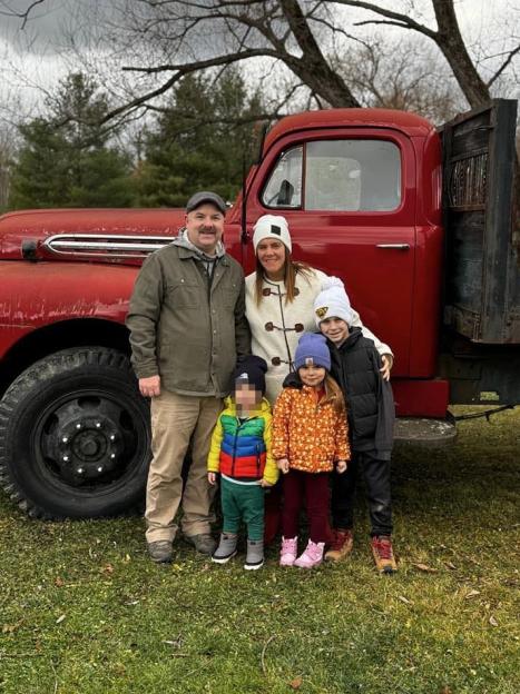 Family photo in front of a red truck.