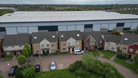 Our homes are dwarfed by 60ft tall monster ‘mega-sheds’ dubbed ‘Britain’s Berlin Wall’ – it’s taking all our sunlight