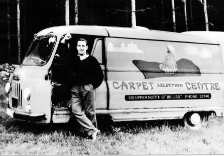 Black and white photo of a man standing next to his Carpet Selection Centre van.