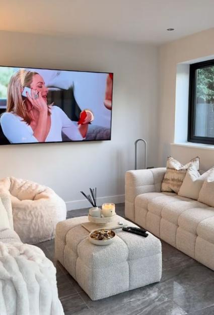 Living room with cream-colored sofa and beanbag chair.