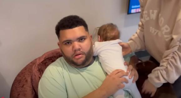 Man holding a baby.