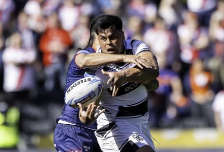 Rugby player tackled during a match.