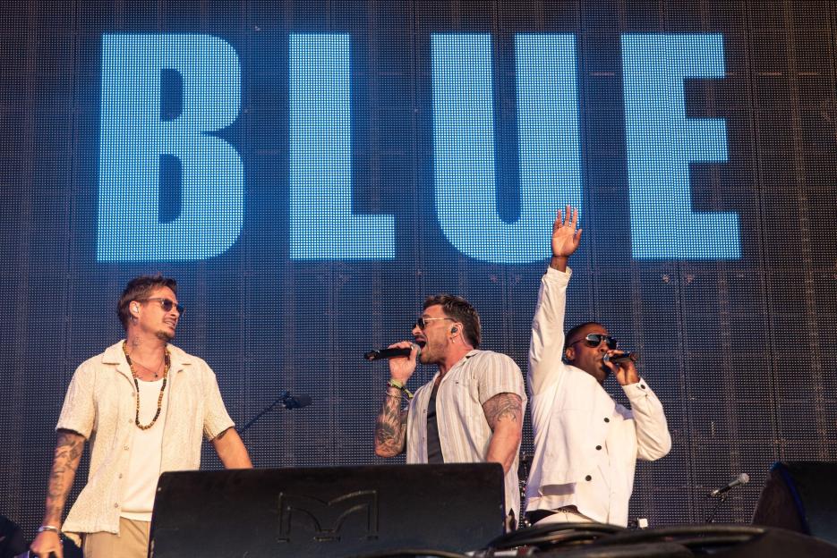 Blue performing at a concert.