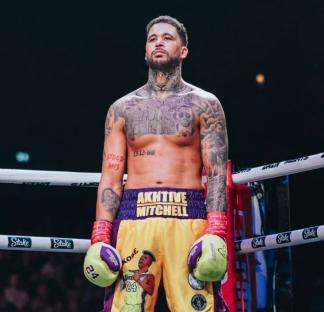 Boxer Akhive Mitchell in boxing ring.