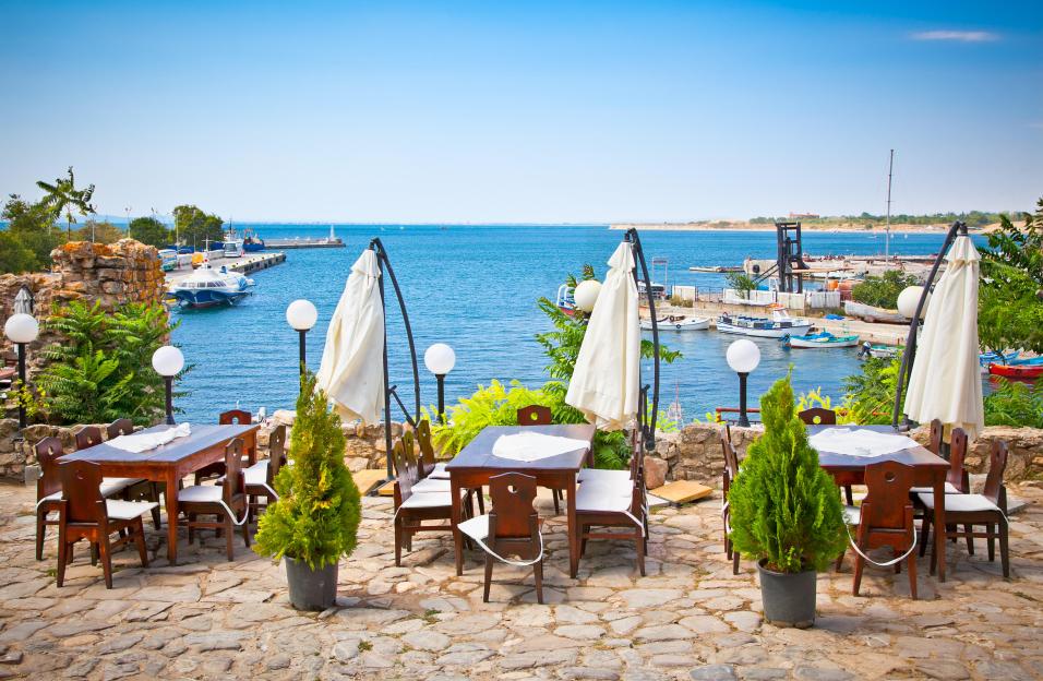 Outdoor cafe overlooking a harbor.