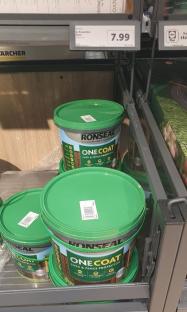 Ronseal One Coat Shed & Fence Protector paint in green buckets on a store shelf.
