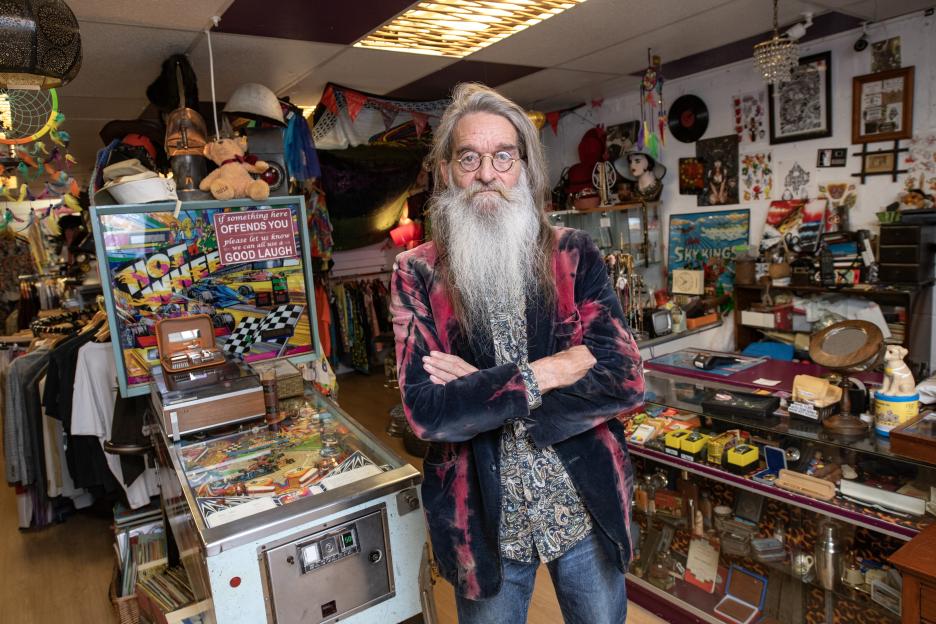 Rob Davies, owner of Run Ragged vintage shop, standing in his shop.