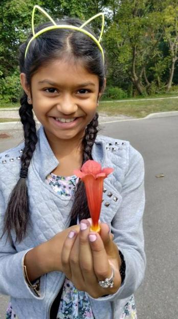 Girl holding a flower.