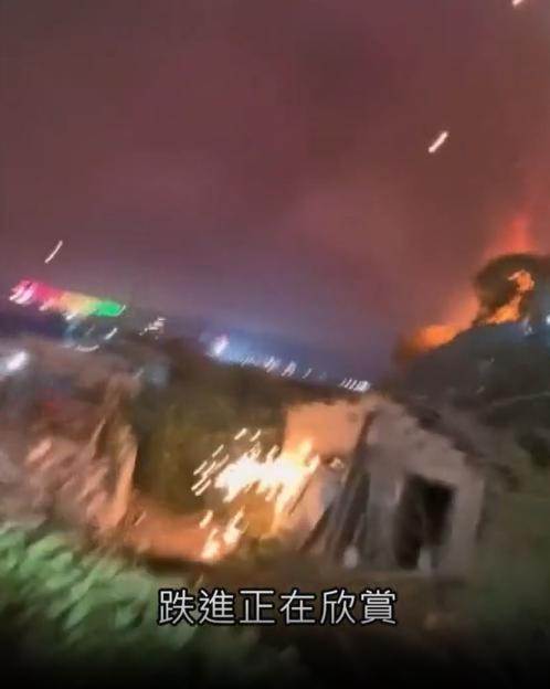 Fire spreading from fireworks display onto nearby structures.