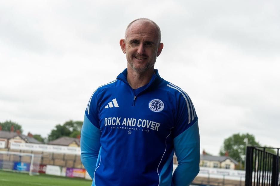 Man in Macclesfield FC jacket.