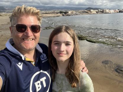 A man and a girl on a beach in the Canary Islands.