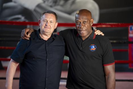 Frank Bruno and Mike Hamilton in a boxing gym.