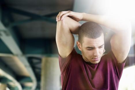 Man stretching his arm.