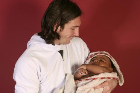 This photo taken in Sept. 2007 shows a 20-year-old Lionel Messi, who had embarked on his legendary Barcelona career just over four years prior, cradling Lamine Yamal, who was merely six months old at the time during a photo session in the dressing room of the Camp Nou stadium in Barcelona, Spain. Lamine Yamal is now a soccer sensation for both Spain and Barcelona and he is still only 16-years-old. (AP Photo/Joan Monfort)